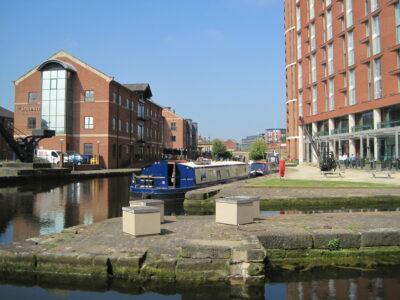 Figure 1: The canal immediately west of River Lock with recent buildings and café culture; the entrances of two disused graving docks are in the foreground, June 2016. All images by R. Goulder.
